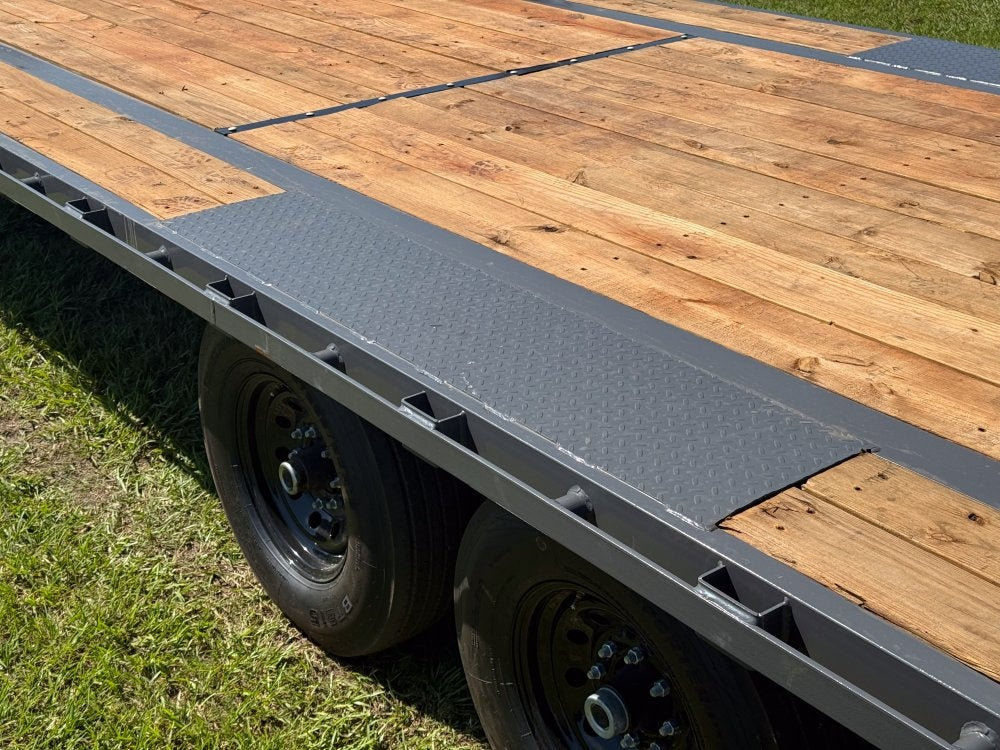 Flatbed trailer deck showing D-ring tie-down points for cargo securement